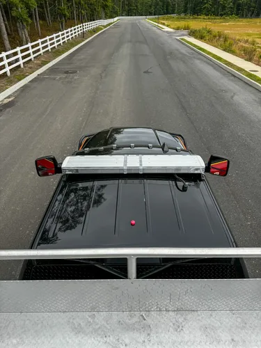 Front-left three-quarter exterior view with side body and rear bay visible.